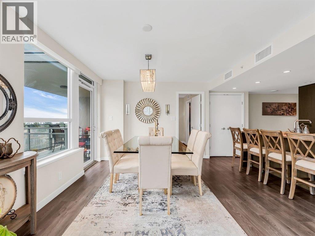 A dining room with a white table and chairs.