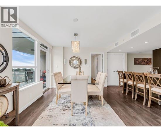 A dining room with a white table and chairs.