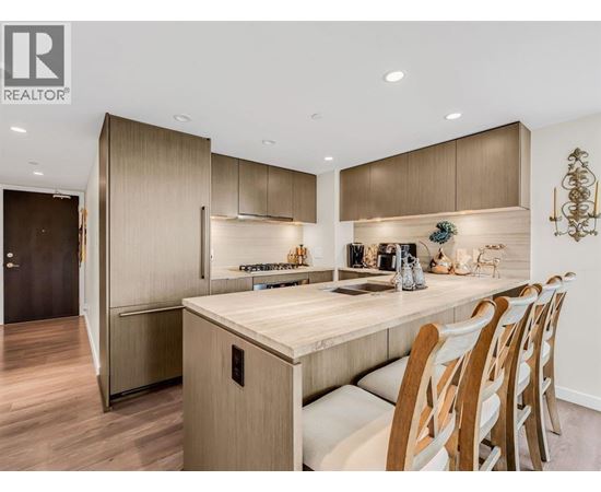 A modern kitchen with wooden cabinets and a center island.