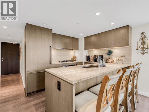 A modern kitchen with wooden cabinets and a center island.