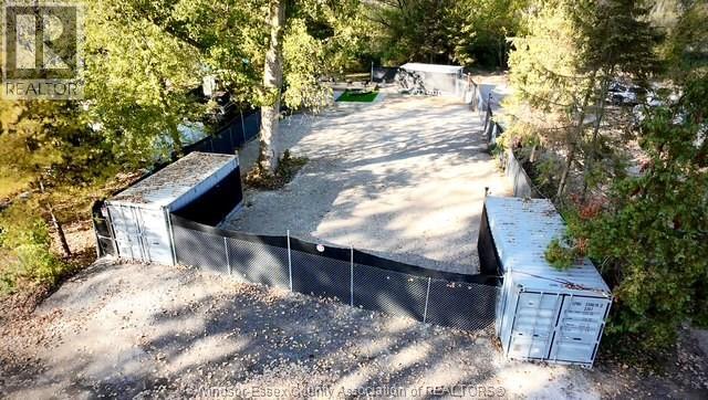 A backyard with a fence and a shed.