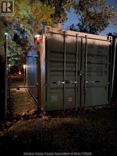 A gate with a sign that says "No Trespassing" is closed.