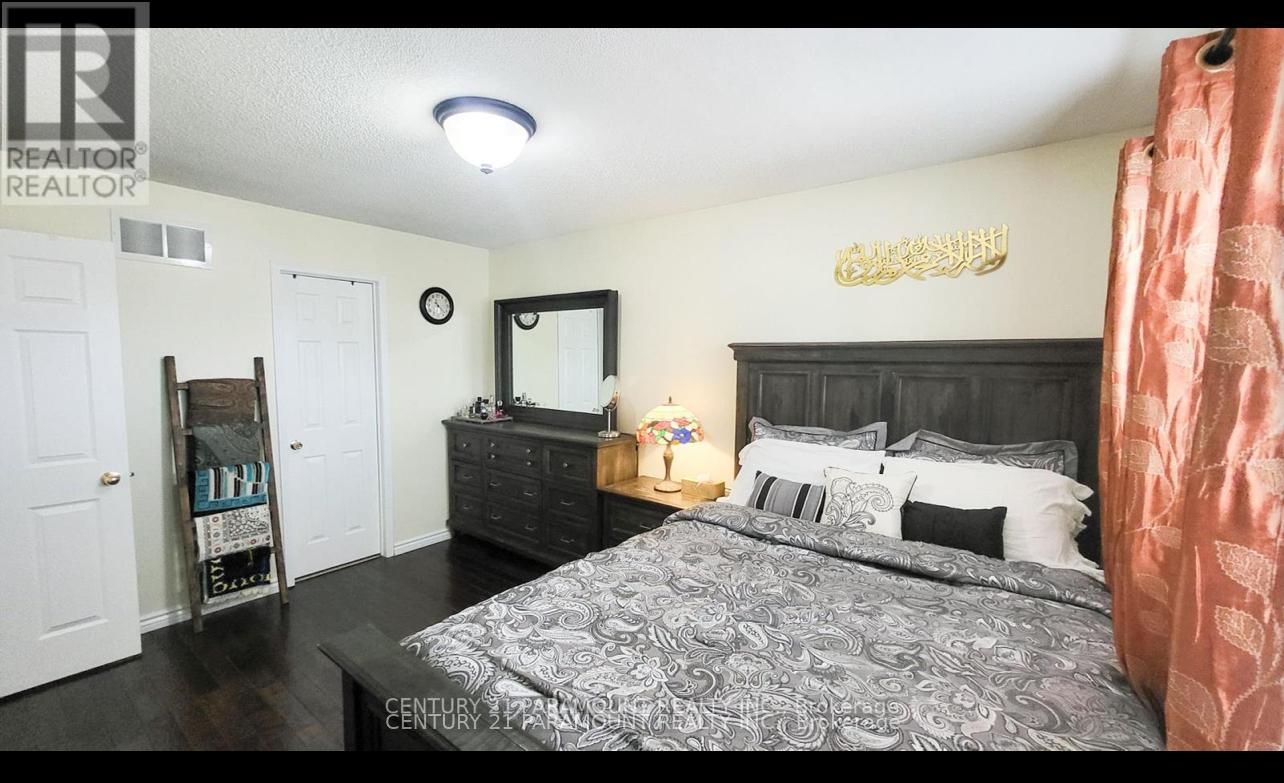 A bedroom with a large bed and a mirror on the wall.