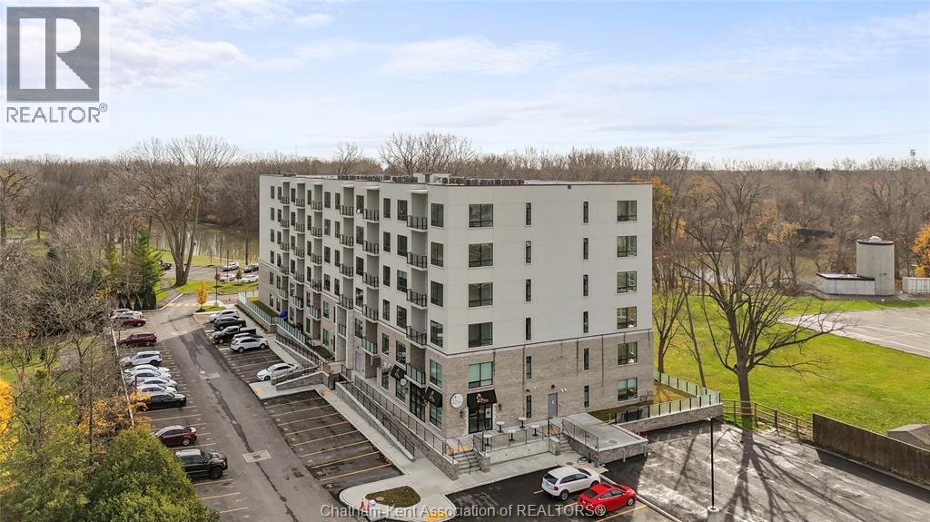 A large white building with a parking lot in front of it.