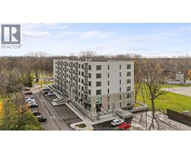 A large white building with a parking lot in front of it.