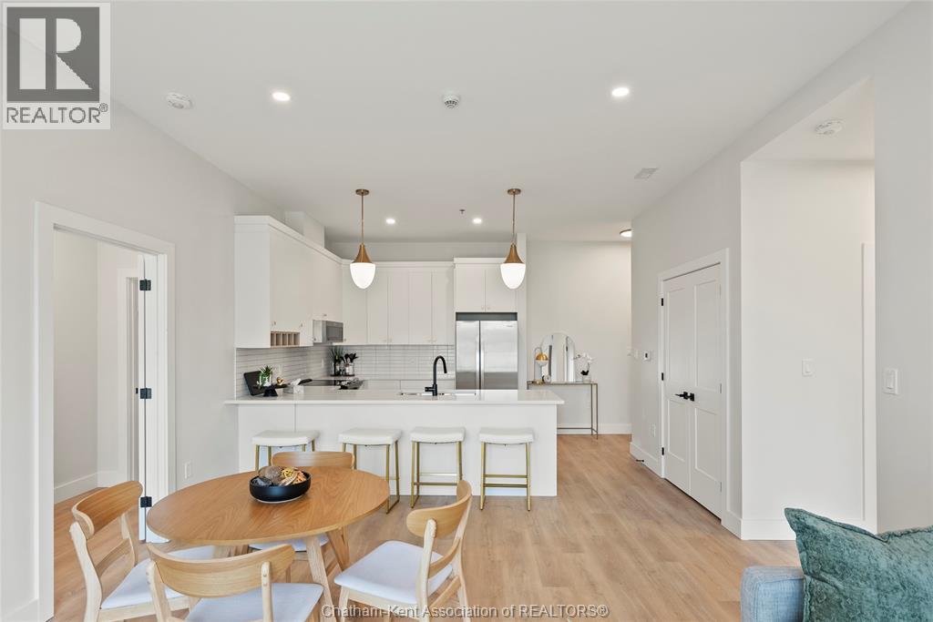 A modern kitchen with a dining table and chairs.