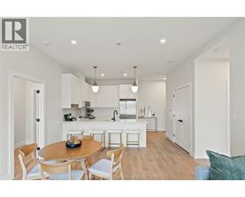 A modern kitchen with a dining table and chairs.