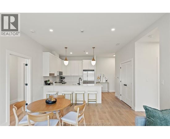 A modern kitchen with a dining table and chairs.