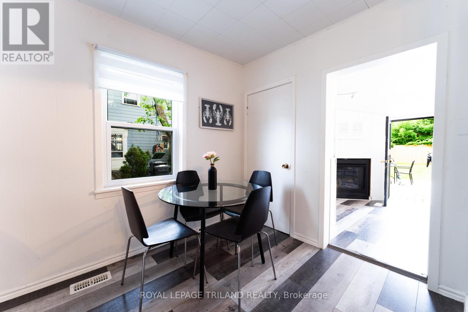 A dining room with a glass table and chairs.