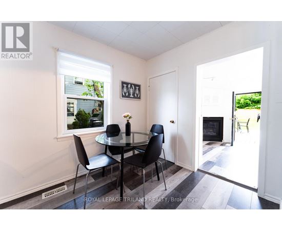 A dining room with a glass table and chairs.