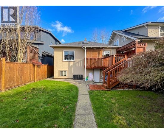 A house with a brown fence and a green lawn.