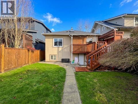 A house with a brown fence and a green lawn.