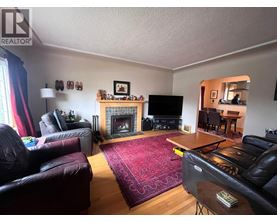A living room with a fireplace and a television.
