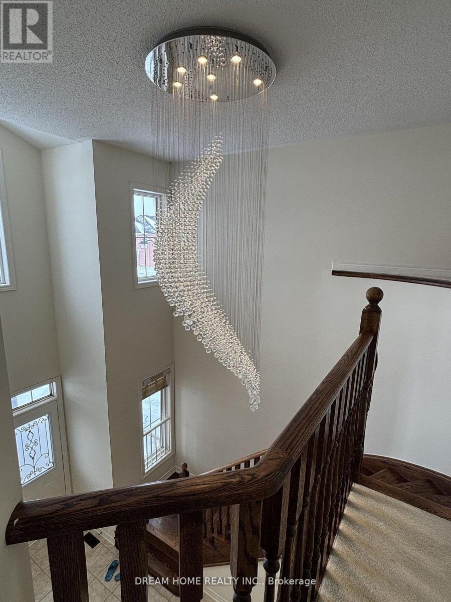 A chandelier with a tree-like design hangs from the ceiling in a spacious room.