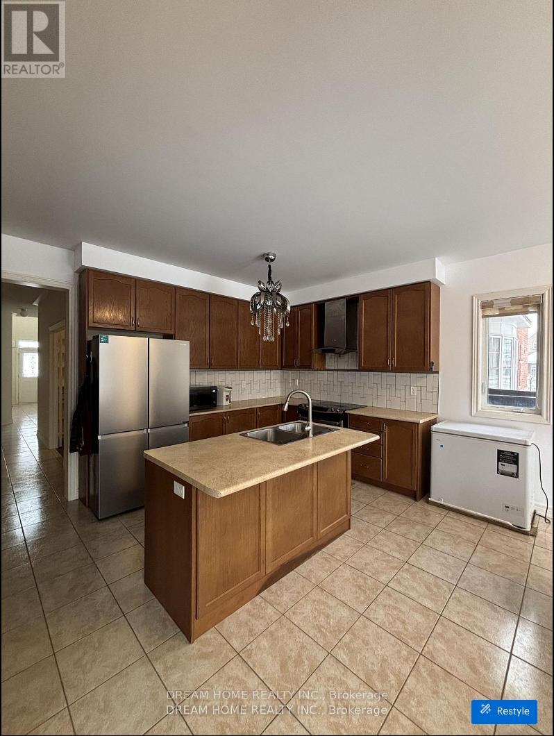 A kitchen with wooden cabinets and a central island.