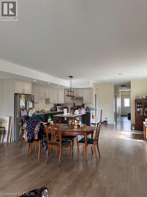 A well-lit kitchen with a dining table set for four.