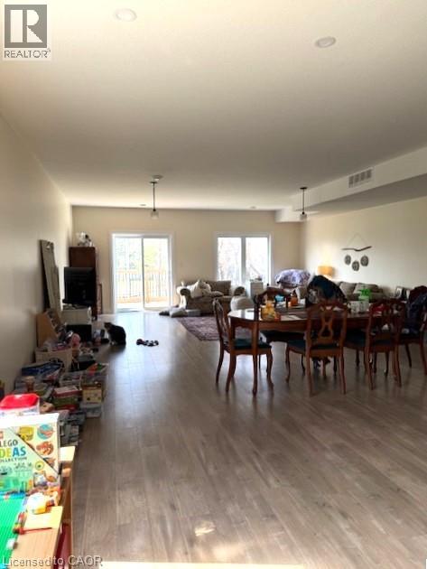A living room with a dining table and chairs.
