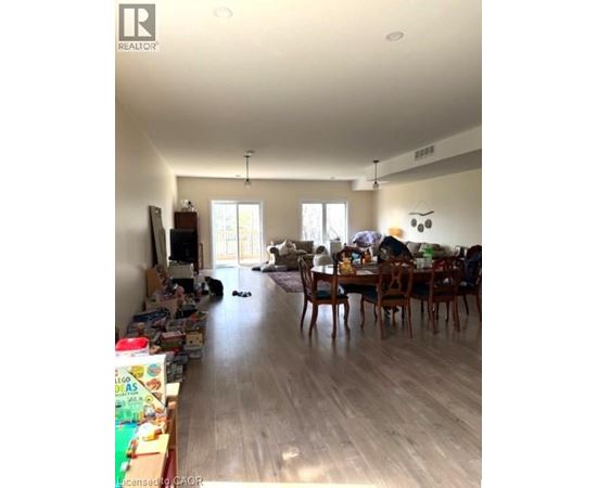 A living room with a dining table and chairs.