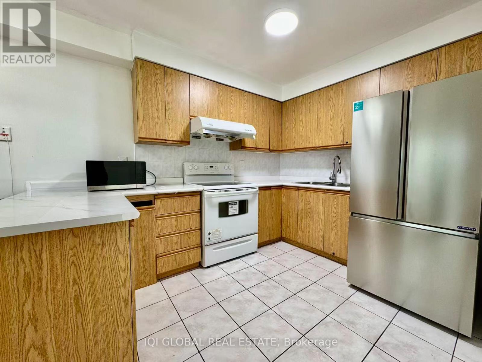 A kitchen with wooden cabinets and a white countertop.