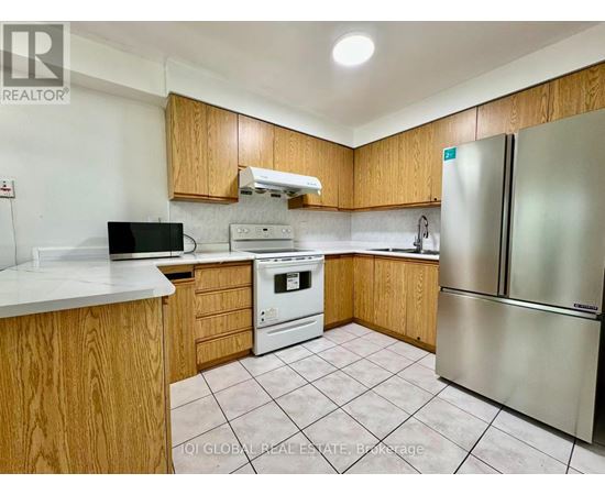 A kitchen with wooden cabinets and a white countertop.