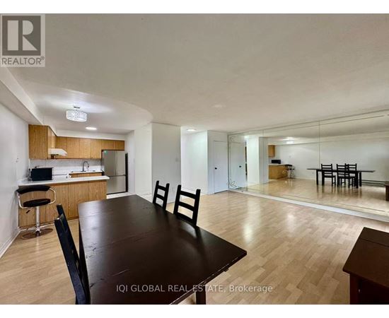 A dining room with a table and chairs is shown.