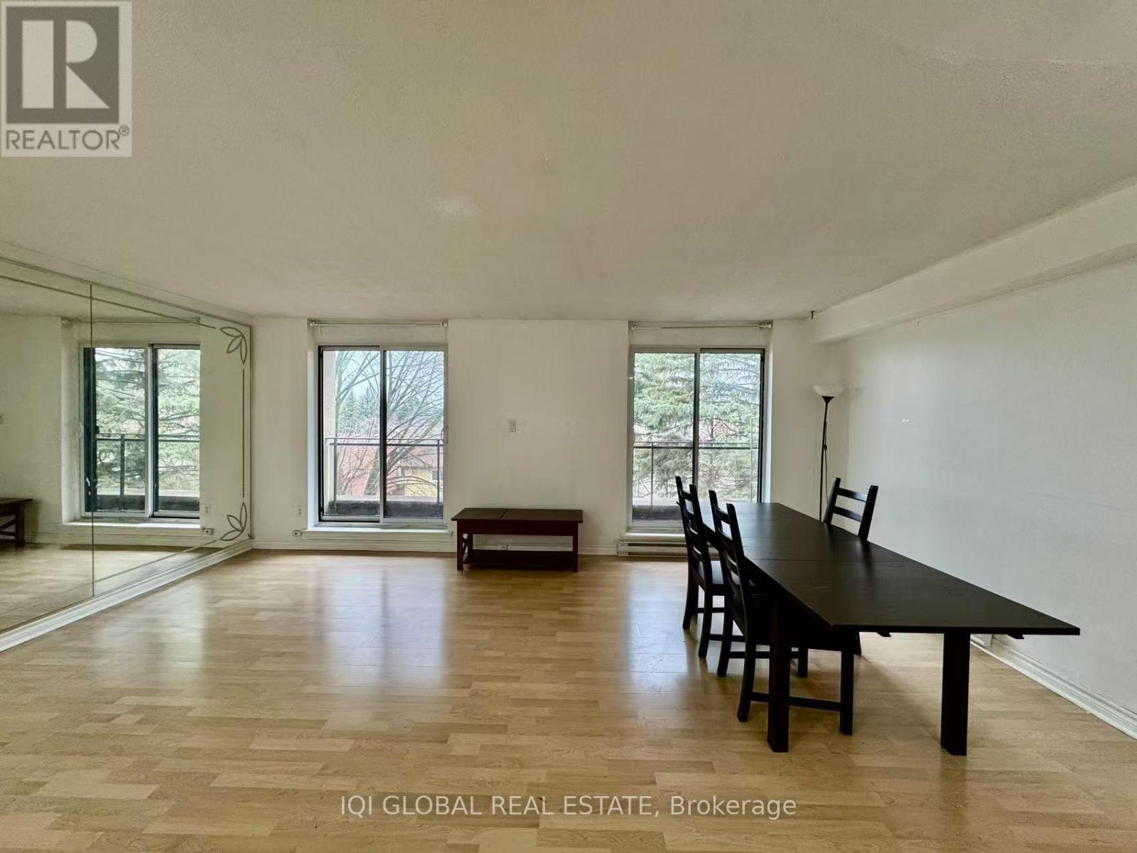 A spacious room with a long table and chairs is available for rent.