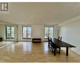 A spacious room with a long table and chairs is available for rent.