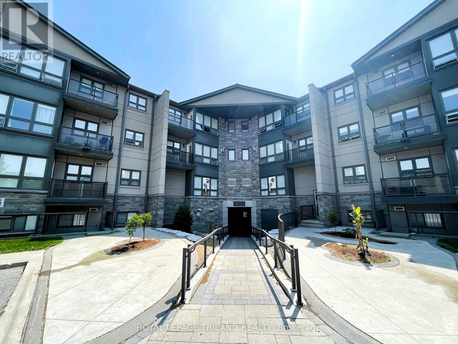 A sunny day at the entrance of a modern apartment complex.