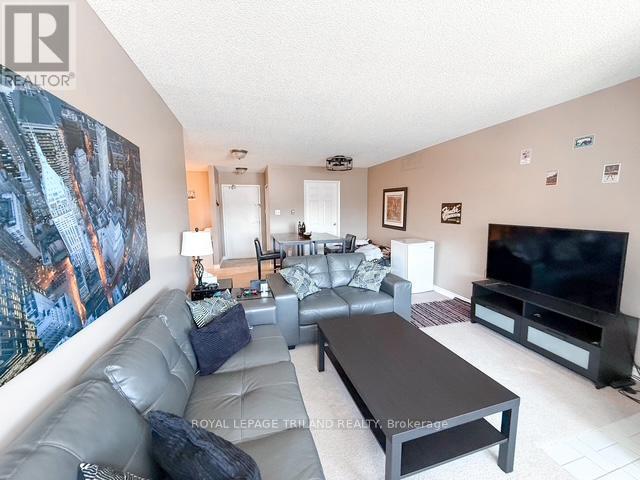 A living room with a large leather sofa and a flat screen TV.