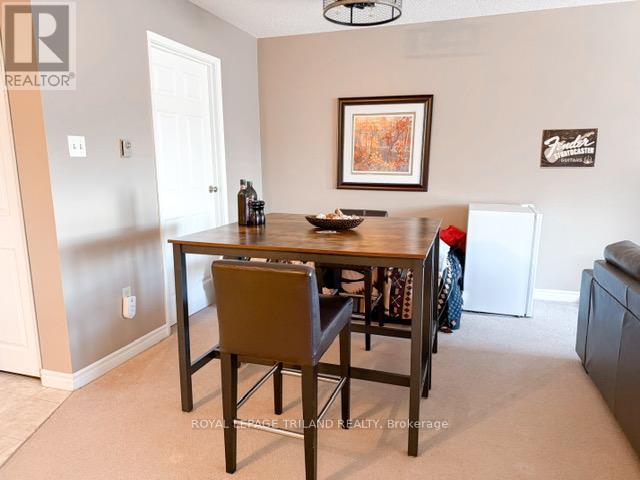 A dining room with a brown chair and a wooden table.