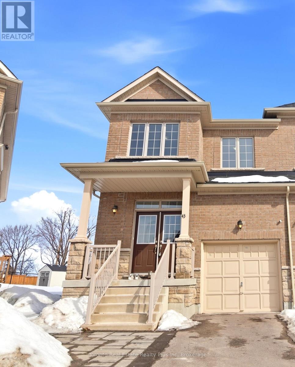 A house with a brown brick exterior and a white garage door.