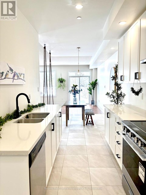 A modern kitchen with white cabinets and a large island.