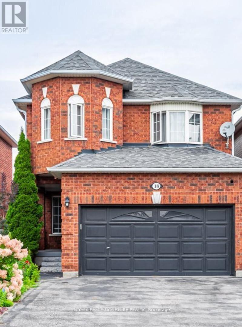 A red brick house with a black garage door.