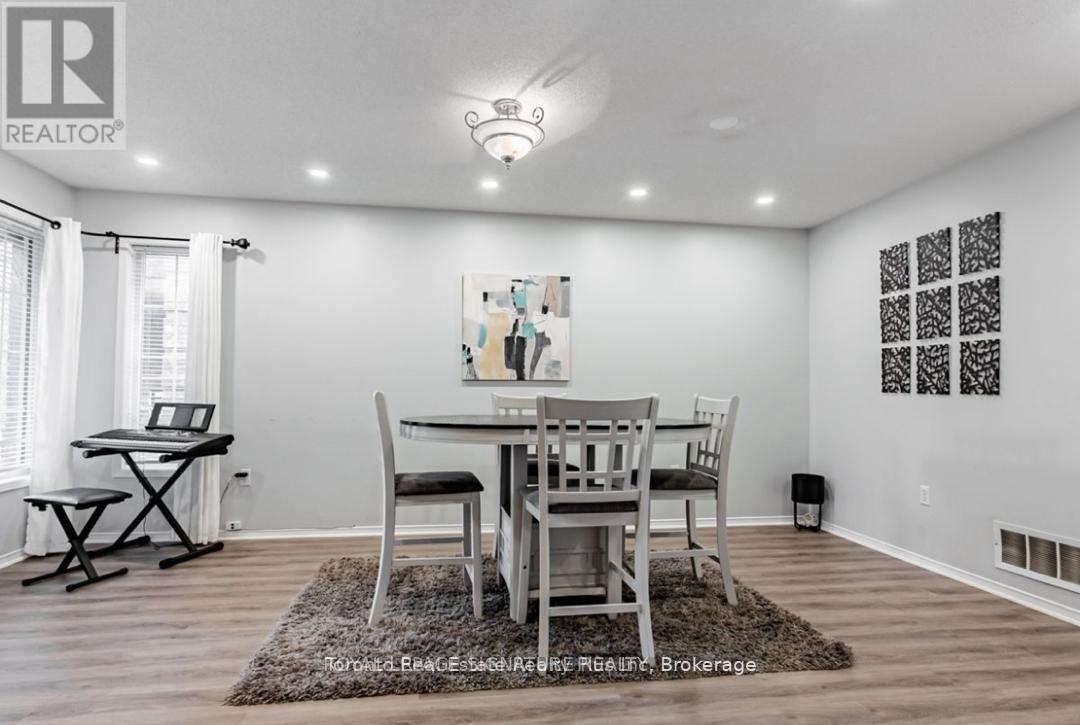A dining room with a table and chairs.