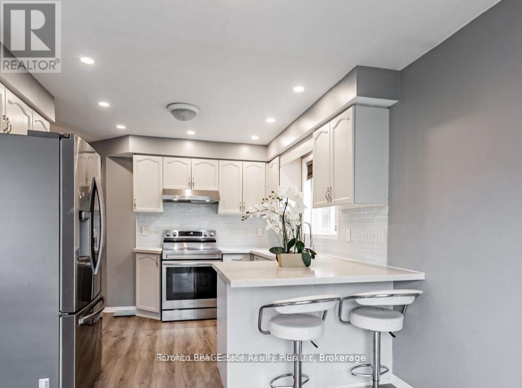 A modern kitchen with white cabinets and a central island.