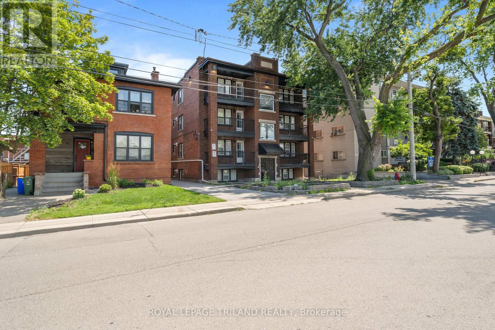 A street view of a residential area with apartment buildings.