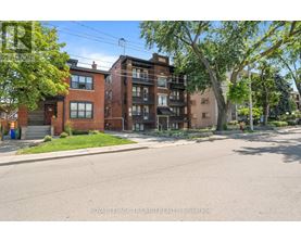 A street view of a residential area with apartment buildings.