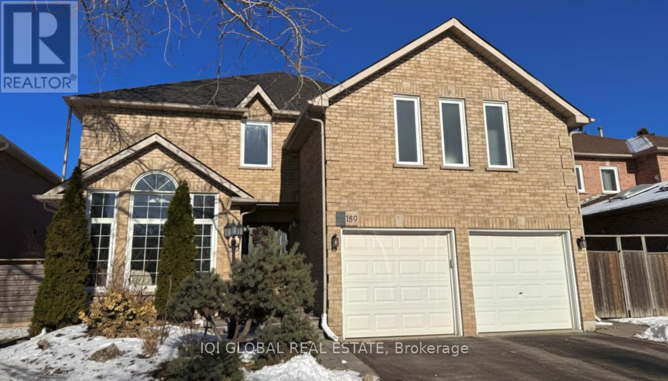 A house with a brown brick exterior and a white garage door.