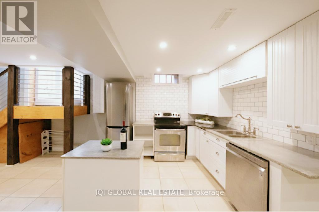A modern kitchen with white cabinets and appliances.