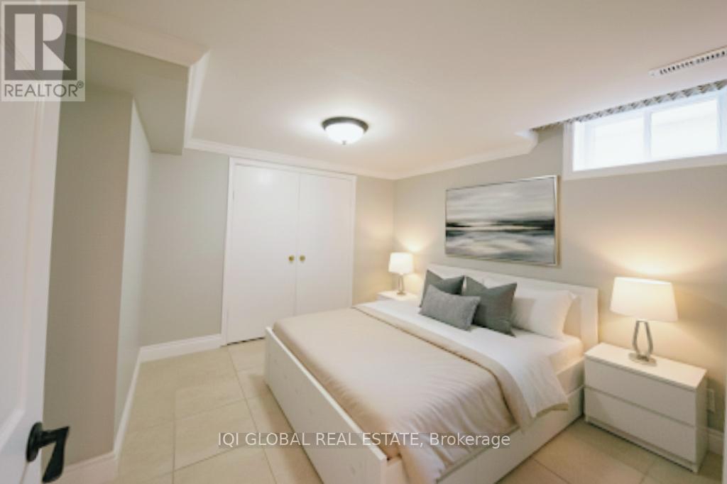 A bedroom with a bed, nightstand, and lamp.