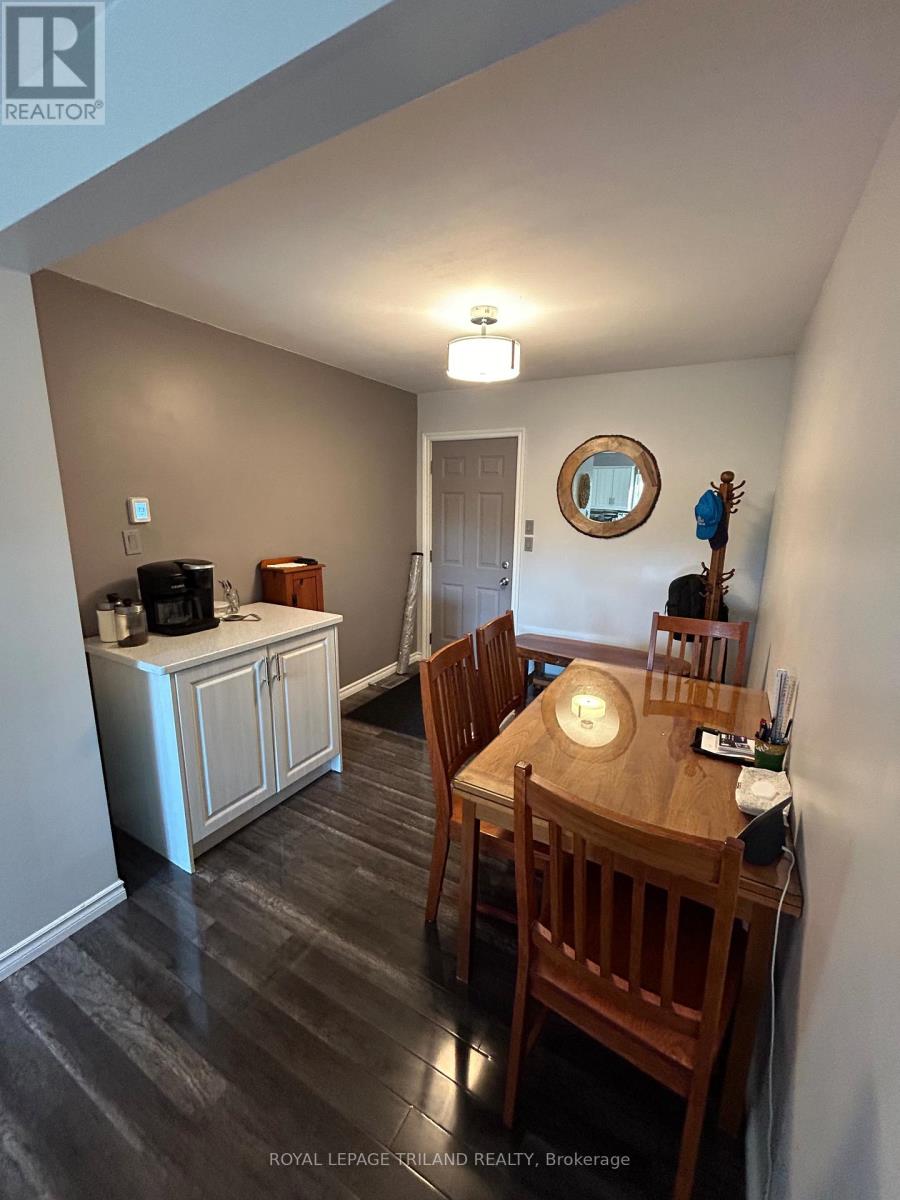 A dining room with a wooden table and chairs.