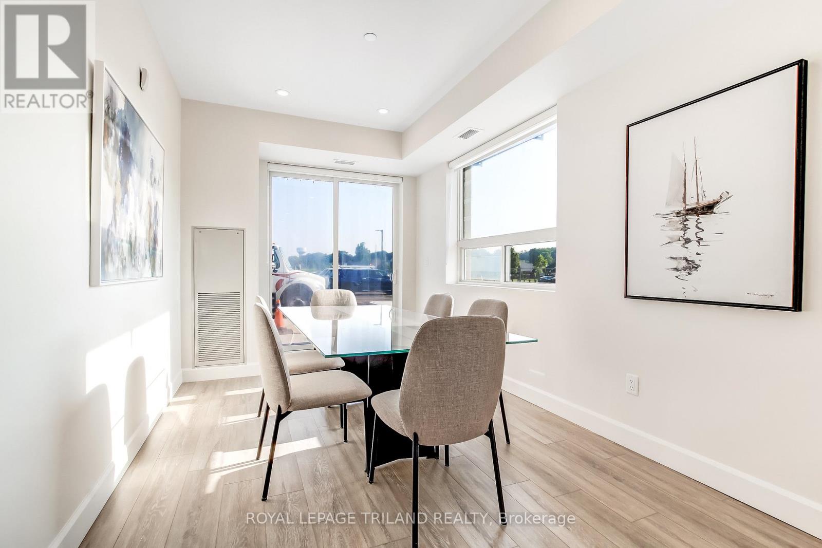 A dining room with a table and chairs.