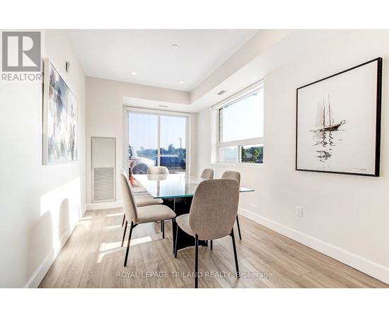 A dining room with a table and chairs.