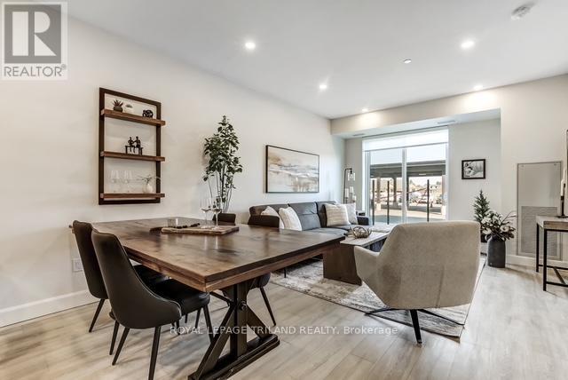 A well-lit dining room with a wooden table and chairs.