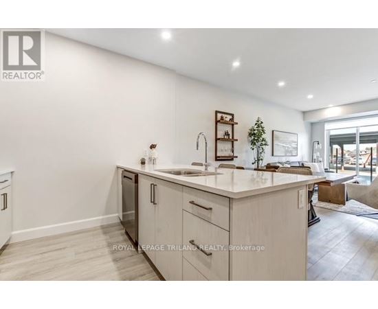 A modern kitchen with white cabinets and a large island.