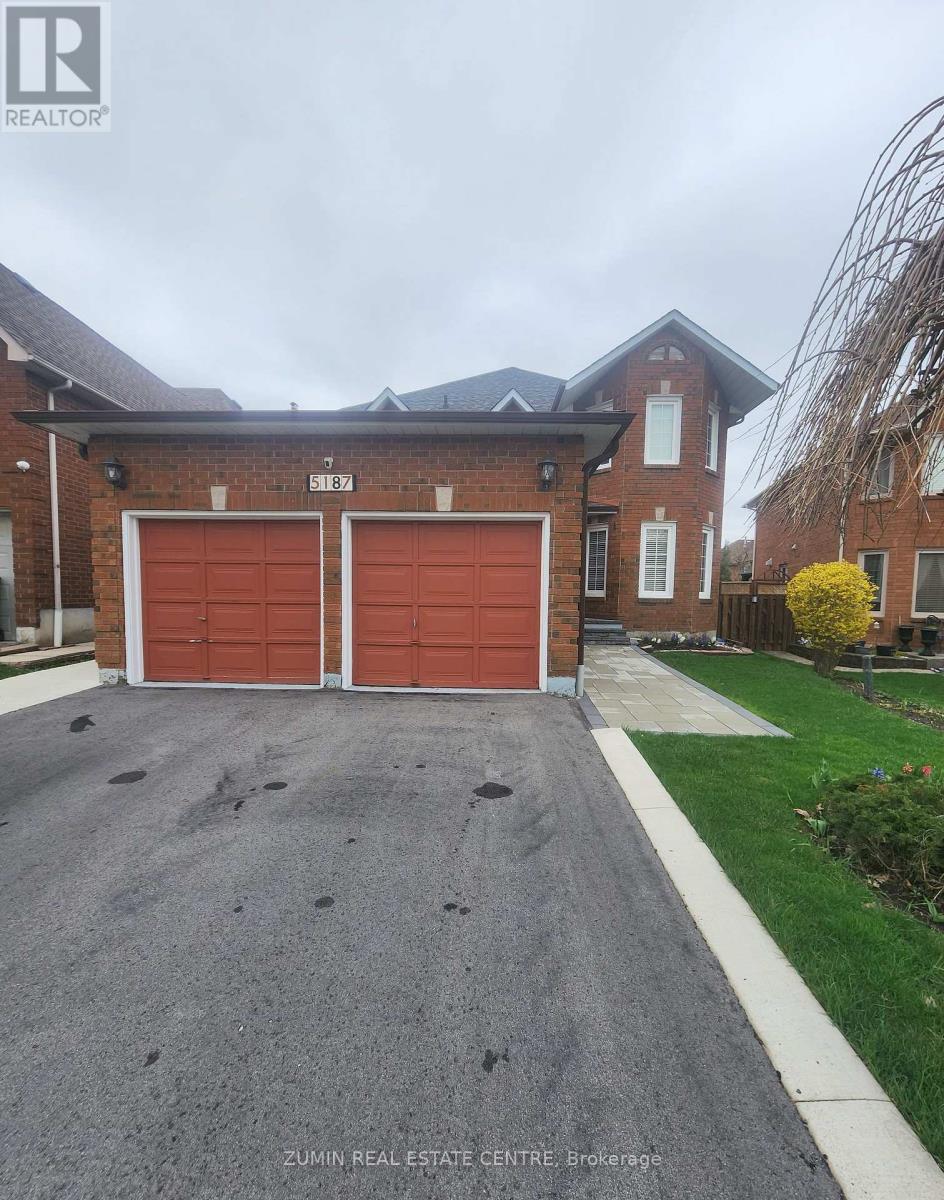 A house with a red garage door is for sale.