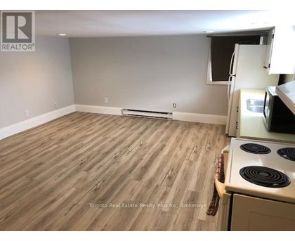 A kitchen with a stove and a refrigerator.