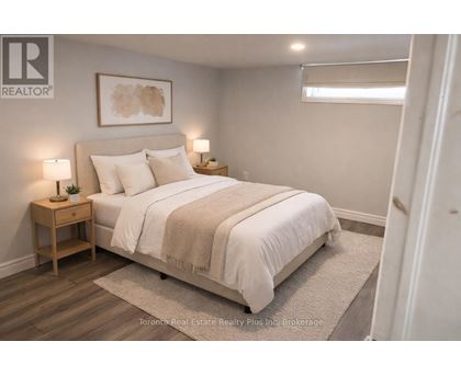 A bedroom with a bed, nightstands, and a rug.
