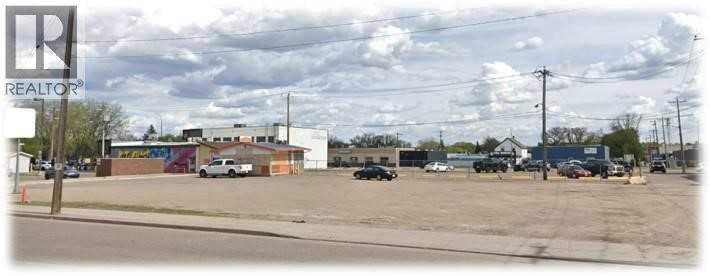 A parking lot with a REALTOR sign in the corner.
