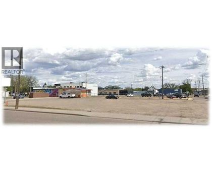 A parking lot with a REALTOR sign in the corner.